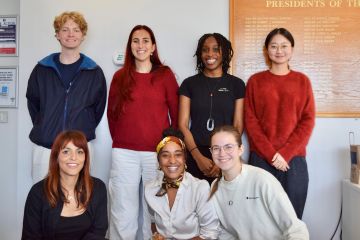 A group of seven male and female alumni and students